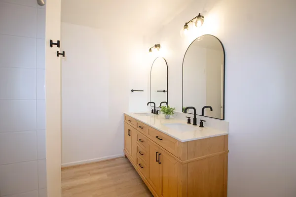 a bathroom with a double vanity sink and a mirror