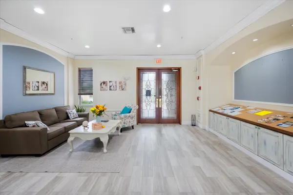 a living room with furniture and a wooden floor