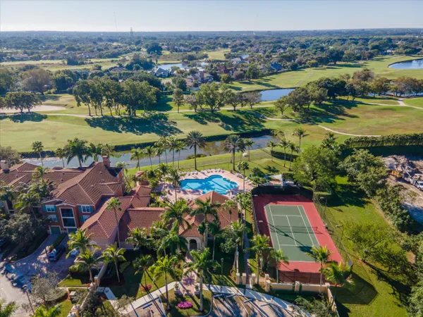 an aerial view of residential houses with outdoor space and lake view