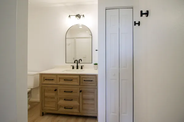 a bathroom with a vanity a sink and a mirror