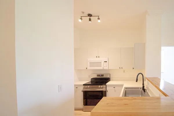 a kitchen with a sink cabinets and stainless steel appliances