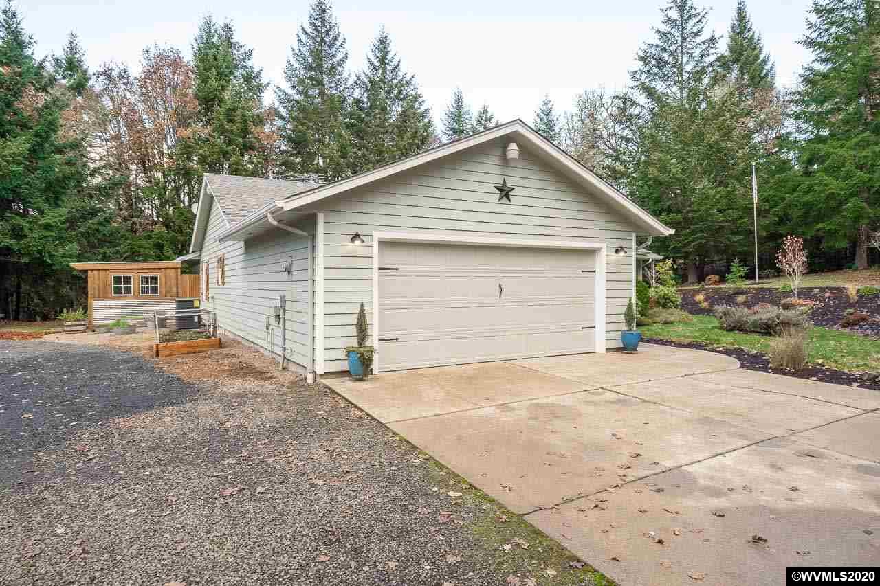 15241 Strong Road Dallas, OR 97338 - Photo 2 of 40 a view of garage yard and front view of a house