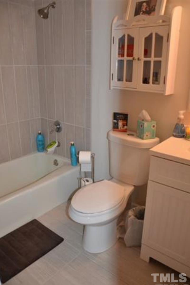 7809 Hemlock Court Raleigh, NC 27615 - Photo 14 of 16 a white toilet sitting next to a bathroom sink