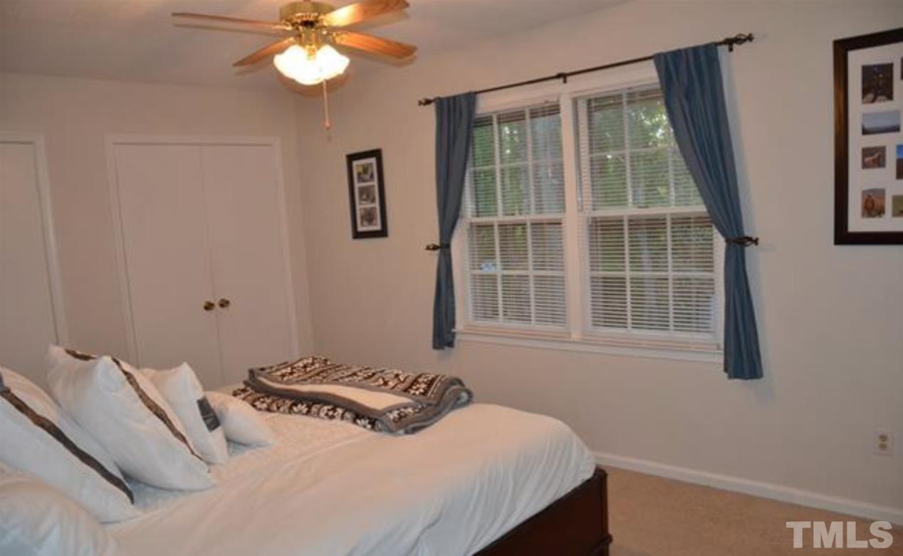7809 Hemlock Court Raleigh, NC 27615 - Photo 9 of 16 a bedroom with a bed and a window