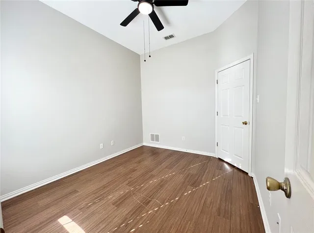 a view of a room with wooden floor