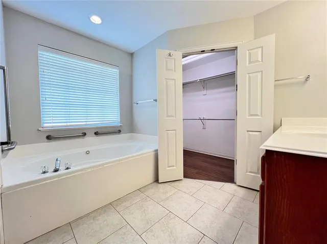 a bathroom with a bathtub and a sink
