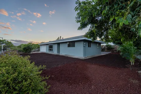 a view of backyard of house with green space