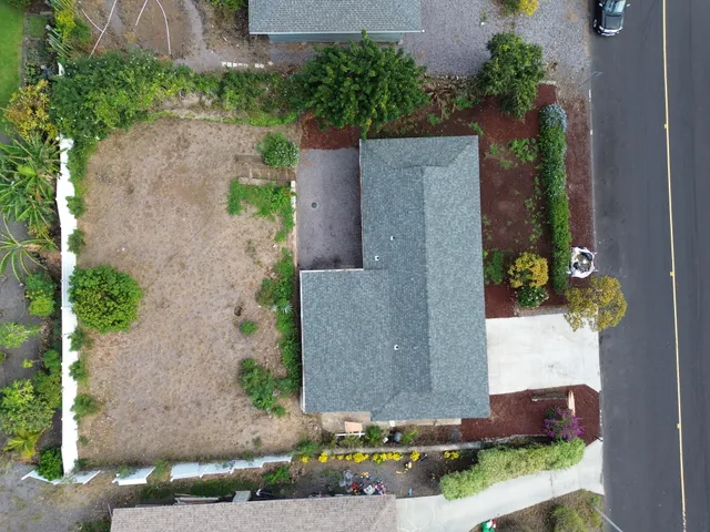 an aerial view of a house with a yard and a fountain