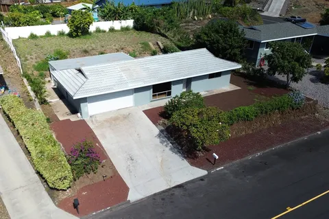 an aerial view of a house with a yard and potted plants