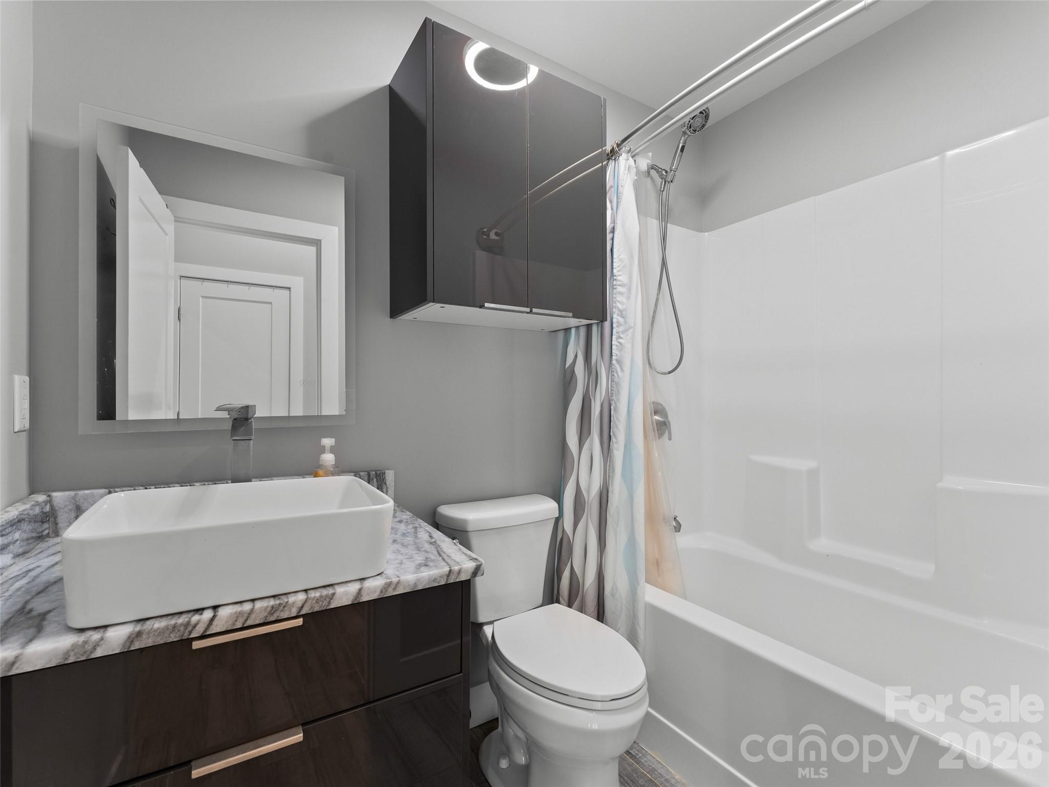 123 Israel Road Candler, NC 28715 - Photo 30 of 44 a bathroom with a sink toilet and shower