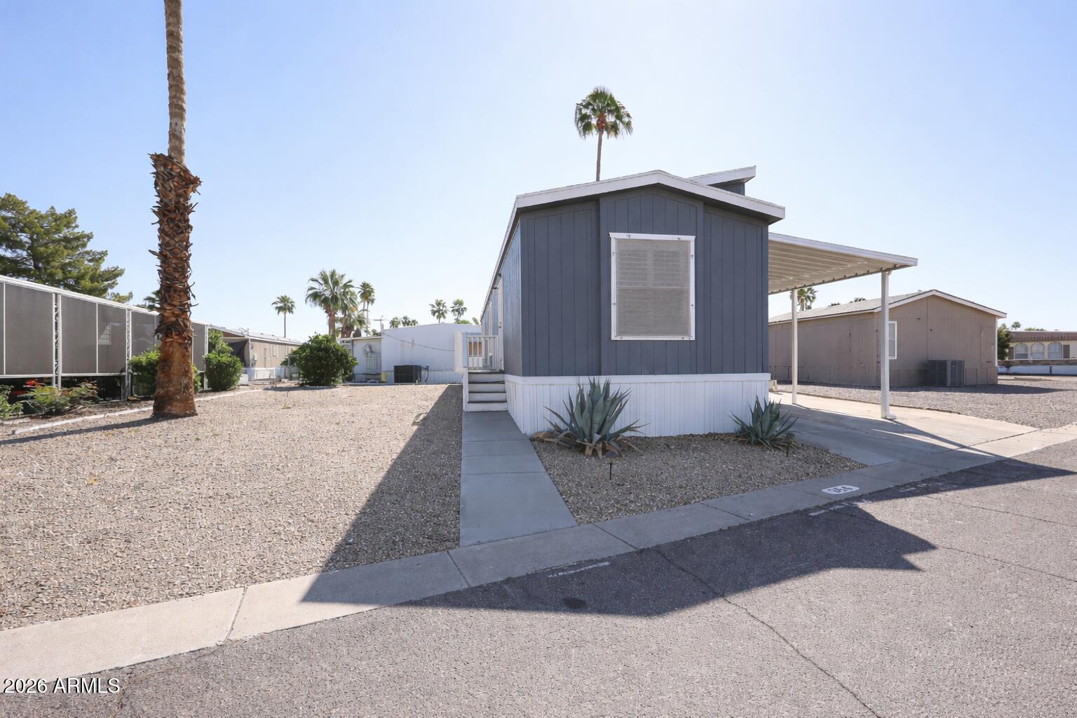 201 South Greenfield Road, Unit 254 Mesa, AZ 85206 - Photo 19 of 35 a front view of a house with a yard