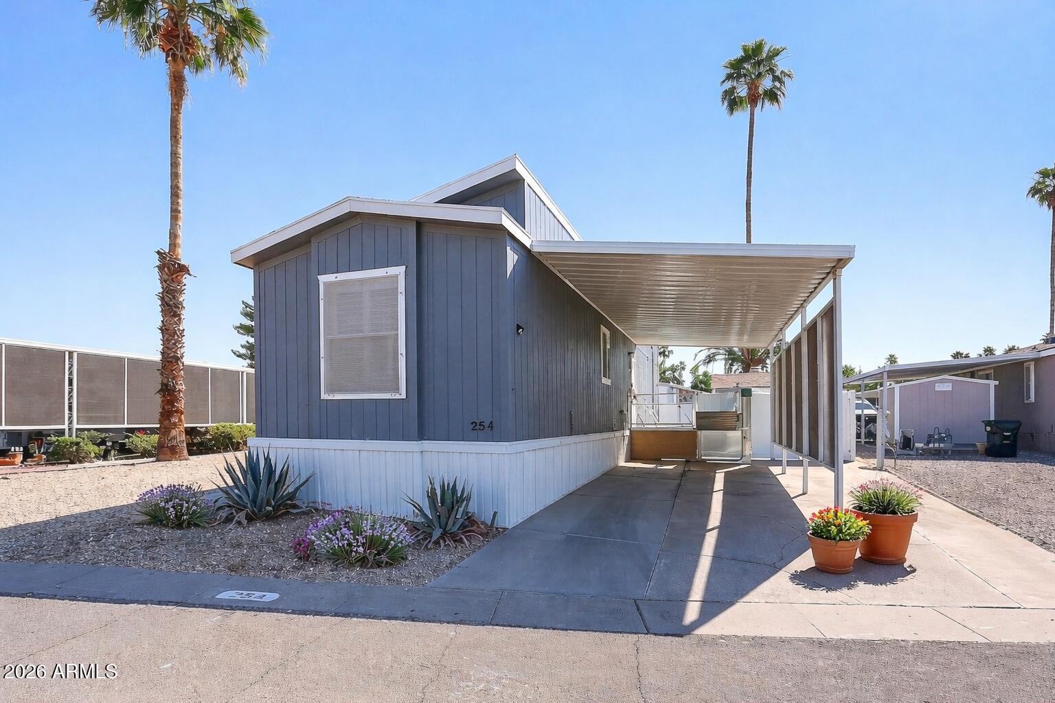 201 South Greenfield Road, Unit 254 Mesa, AZ 85206 - Photo 2 of 35 a front view of a house with garden