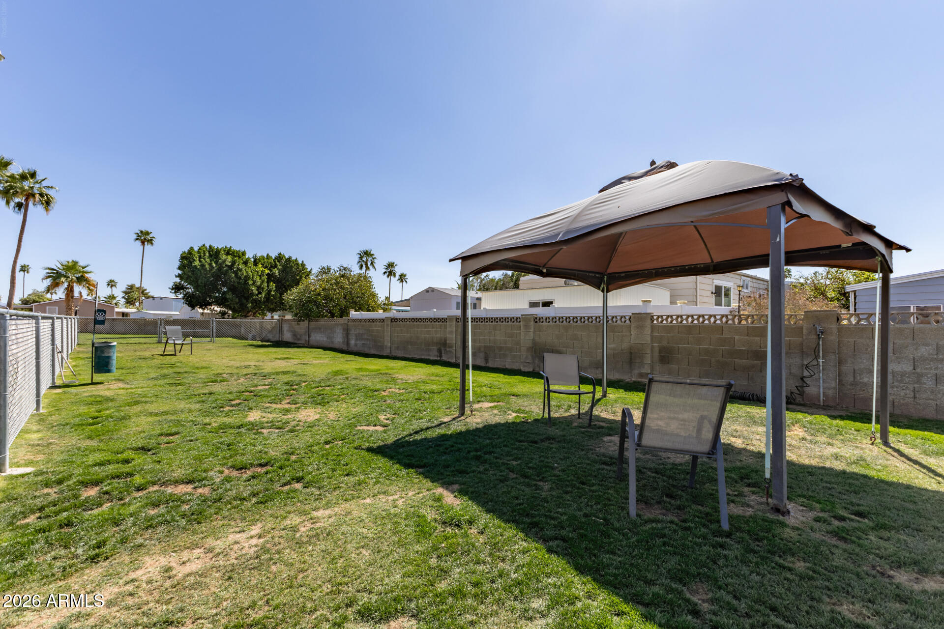 201 South Greenfield Road, Unit 254 Mesa, AZ 85206 - Photo 26 of 35 a view of a bench in a backyard