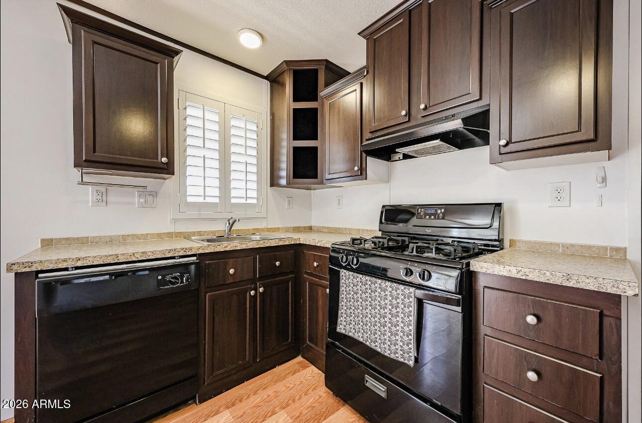 201 South Greenfield Road, Unit 254 Mesa, AZ 85206 - Photo 5 of 35 a kitchen with stainless steel appliances granite countertop a stove microwave and sink
