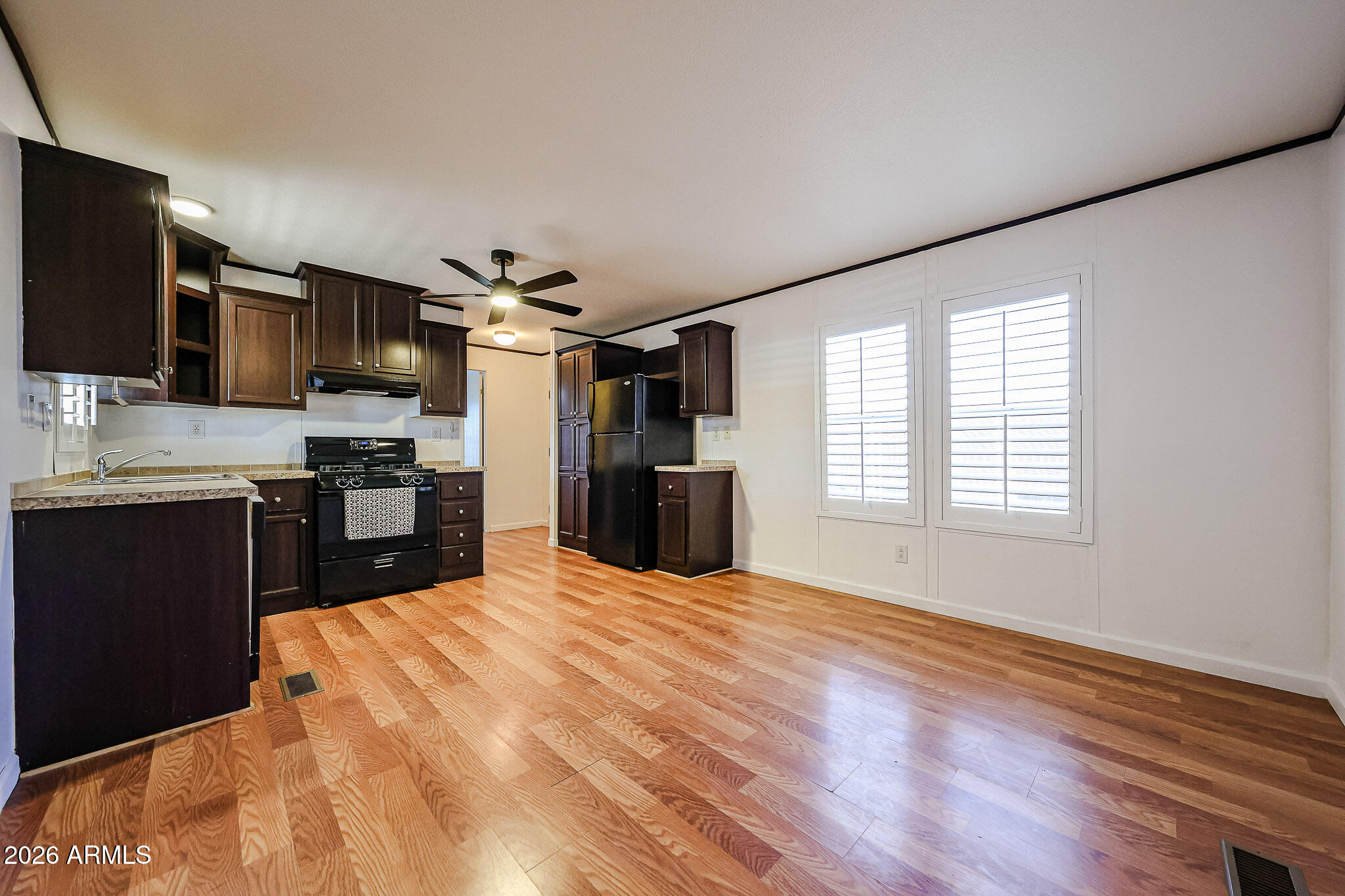 201 South Greenfield Road, Unit 254 Mesa, AZ 85206 - Photo 7 of 35 a large kitchen with kitchen island granite countertop stainless steel appliances cabinets a sink and a large window