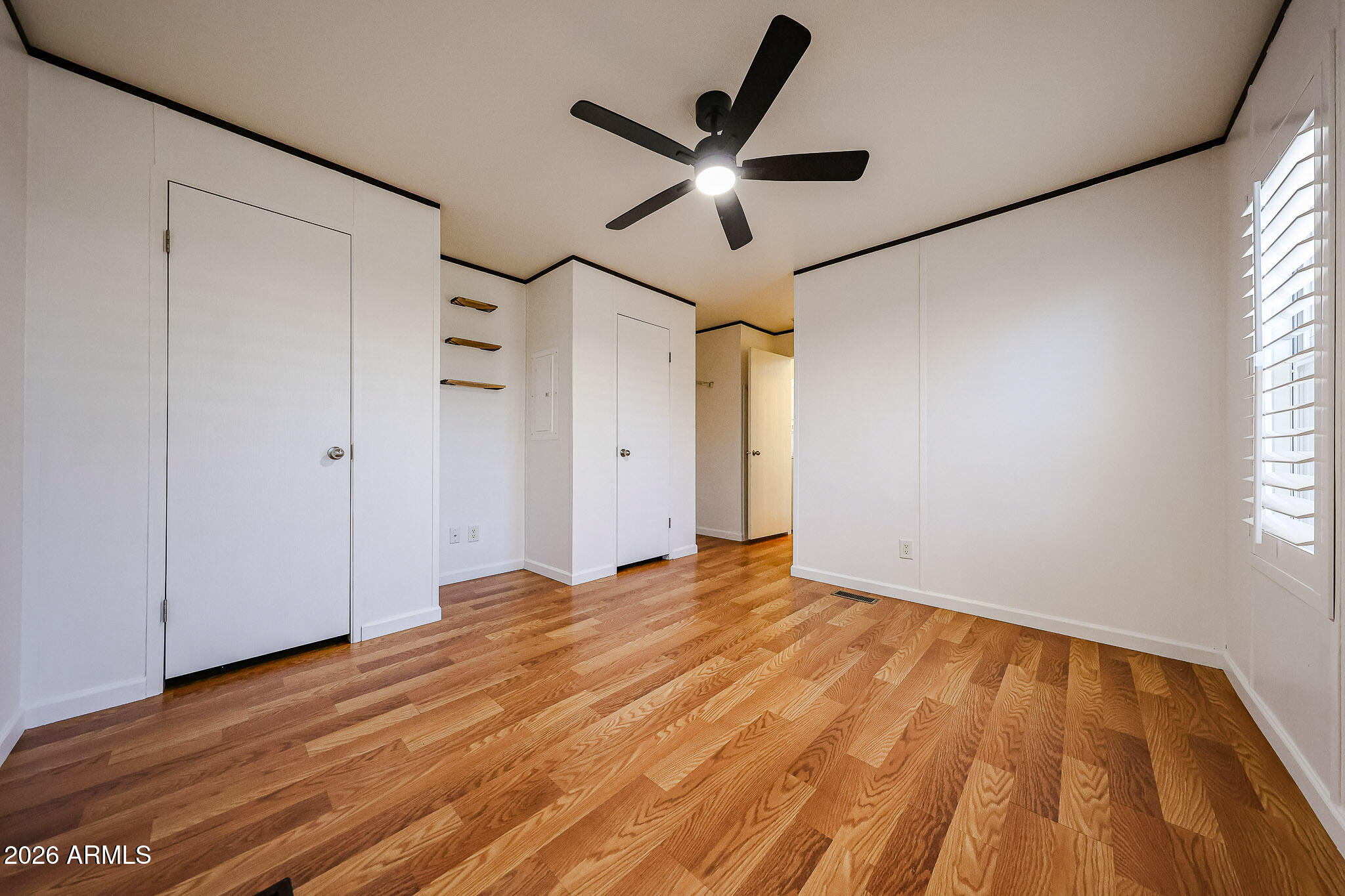 201 South Greenfield Road, Unit 254 Mesa, AZ 85206 - Photo 10 of 35 a view of empty room with wooden floor and fan