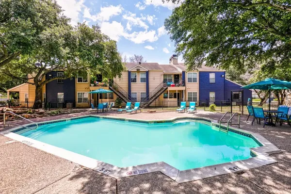 a view of a house with swimming pool and sitting area