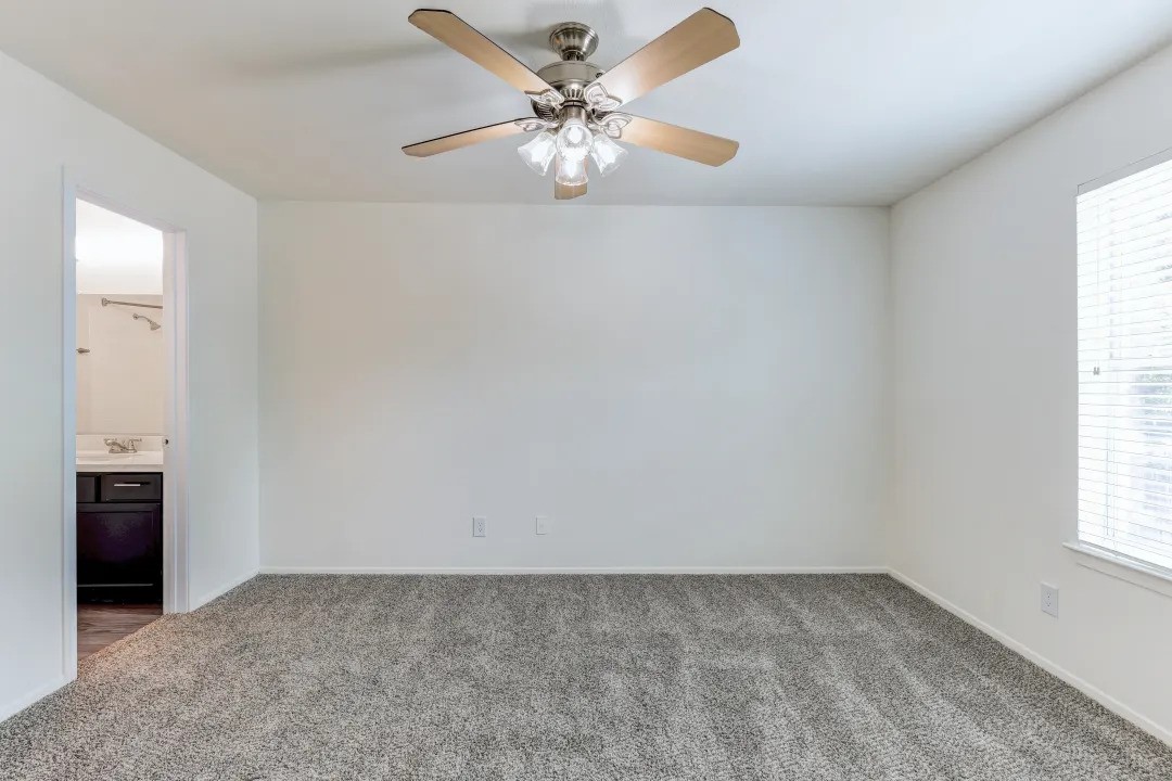 1100 Graham Drive, Unit 1602 Tomball, TX 77375 - Photo 9 of 27 an empty room with windows and fan