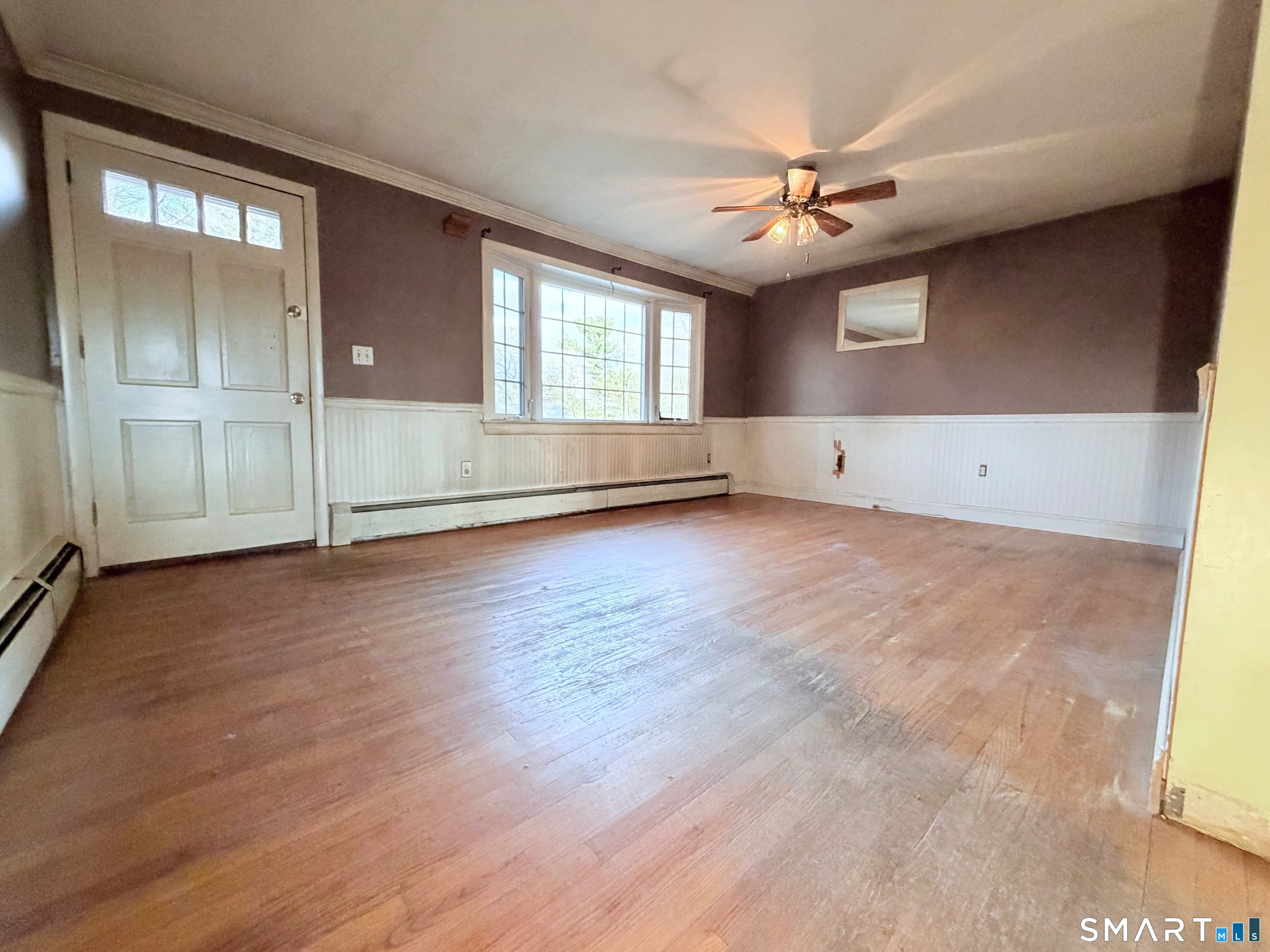 14 Wilson Lane Vernon, CT 06066 - Photo 2 of 19 an empty room with wooden floor fan and windows