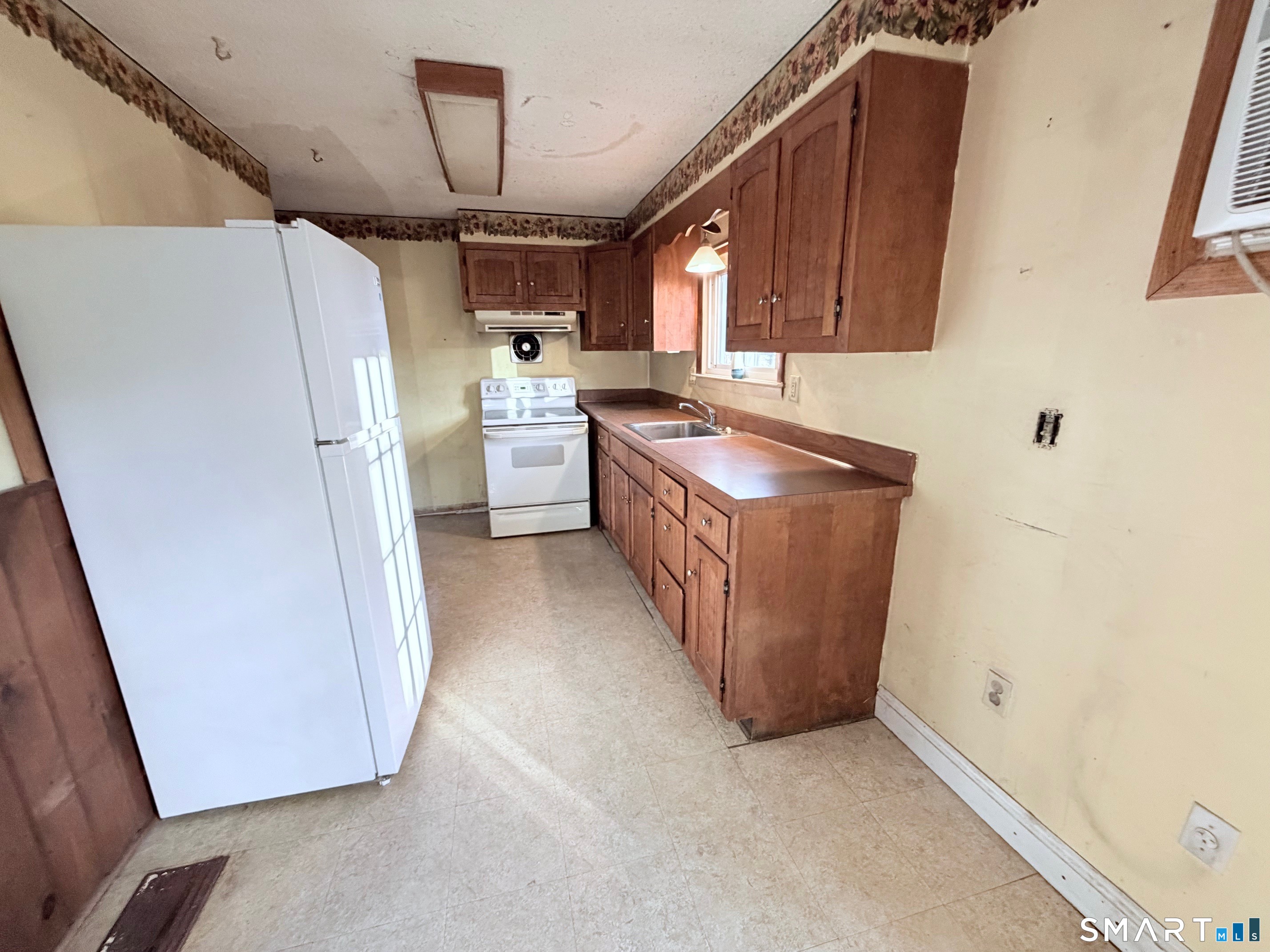 14 Wilson Lane Vernon, CT 06066 - Photo 4 of 19 a kitchen with refrigerator and cabinets