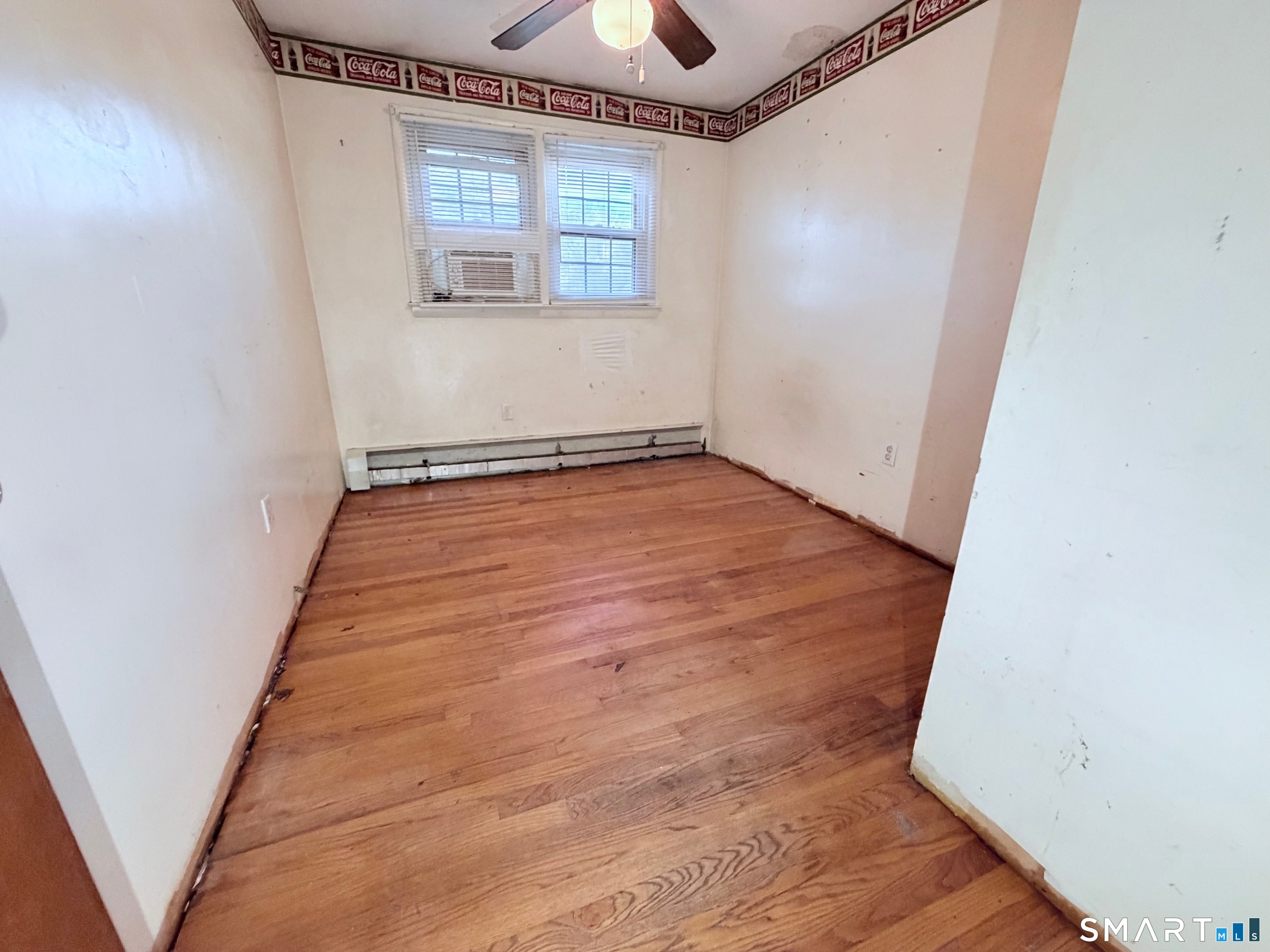 14 Wilson Lane Vernon, CT 06066 - Photo 6 of 19 an empty room with wooden floor chandelier fan and windows