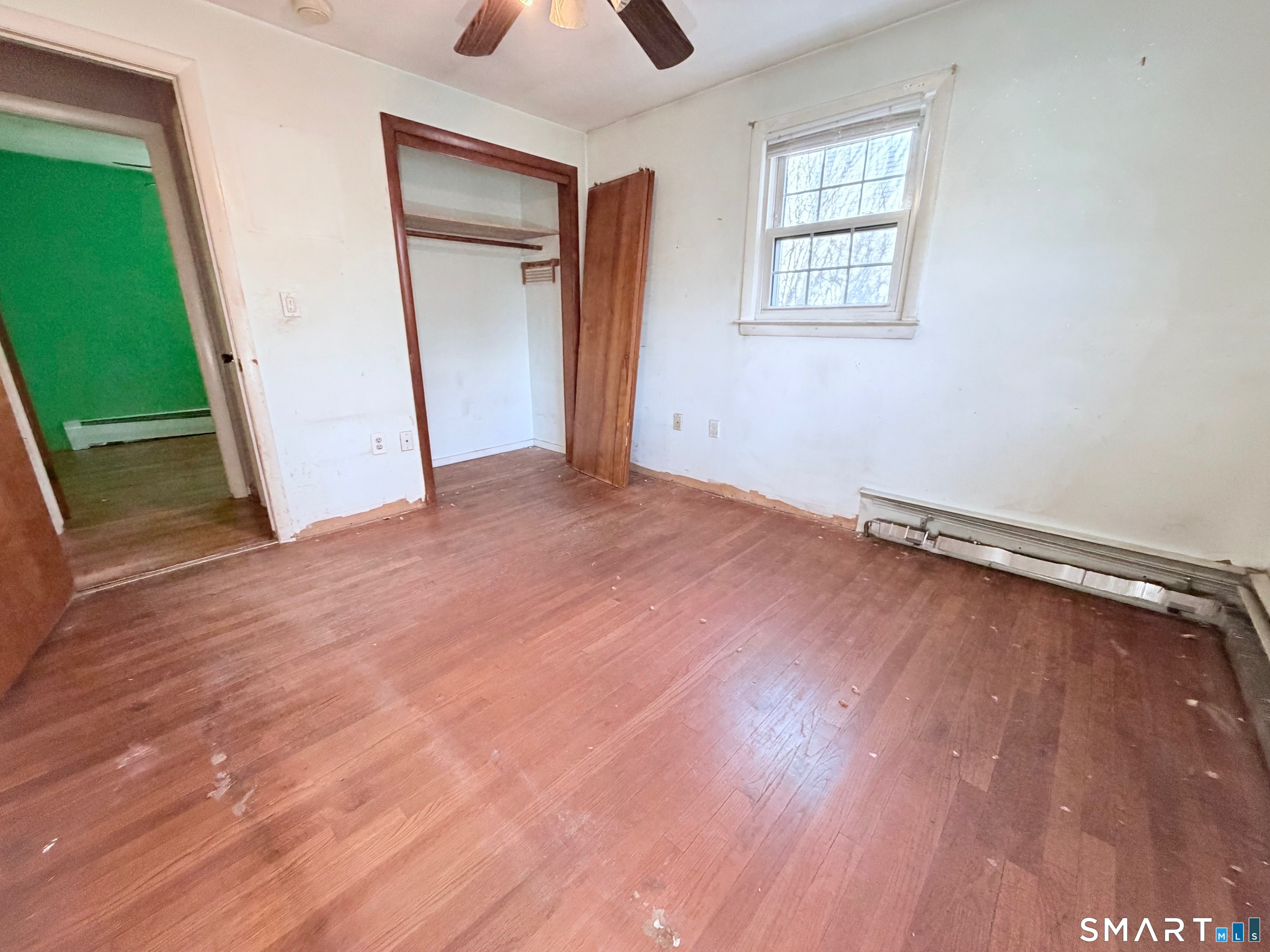 14 Wilson Lane Vernon, CT 06066 - Photo 8 of 19 an empty room with wooden floor cabinet and windows