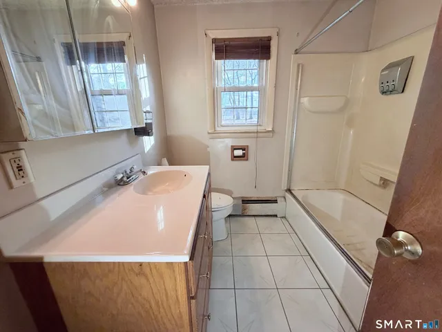 a en suite bathroom with a tub shower and sink