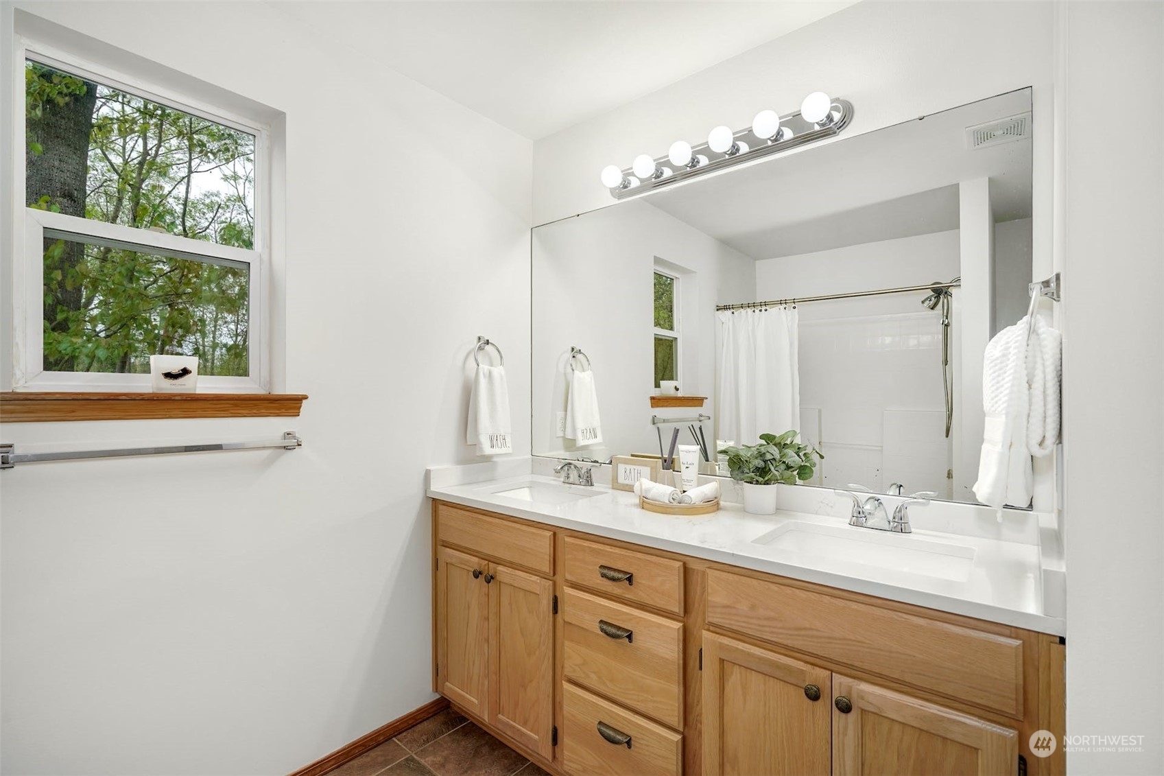 2010 Magnolia Road Lynnwood, WA 98036 - Photo 14 of 22 a bathroom with a double vanity sink and a mirror