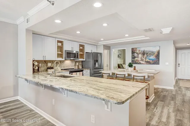 a kitchen with stainless steel appliances granite countertop a sink and cabinets