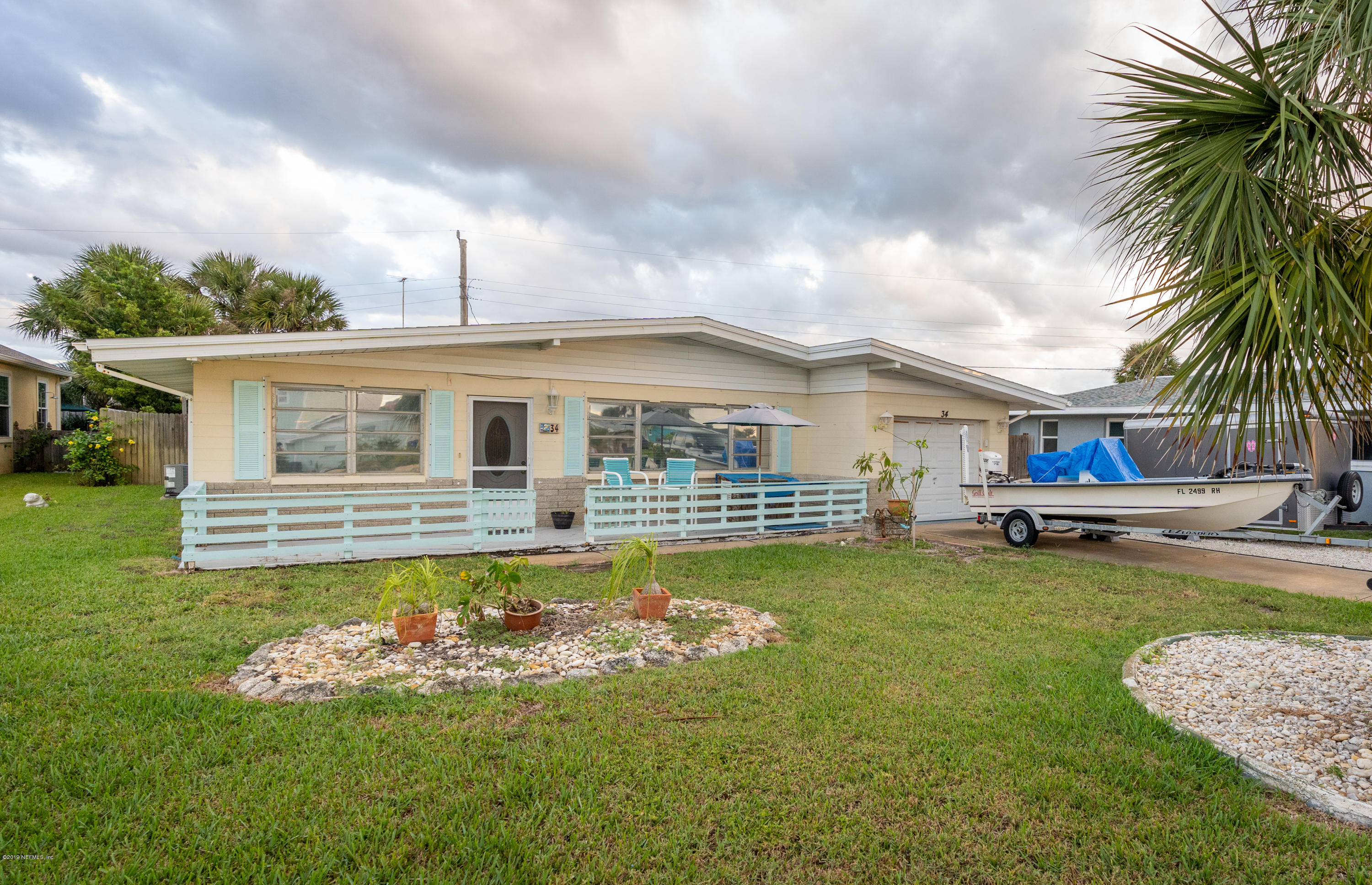 a front view of a house with swimming pool having outdoor seating