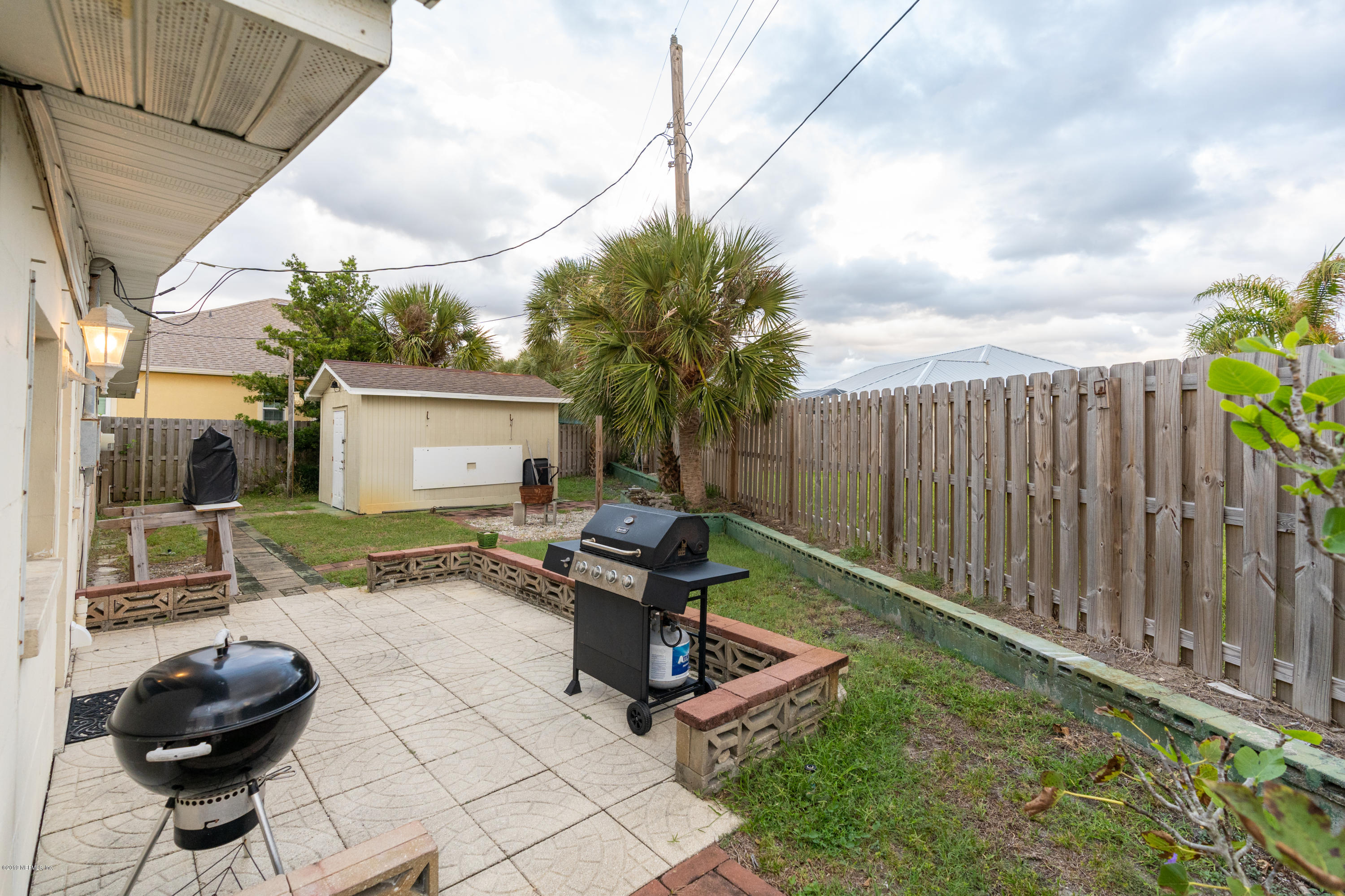 34 Ocean Drive St. Augustine, FL 32080 - Photo 11 of 36 a view of a chair and tables in backyard of the house