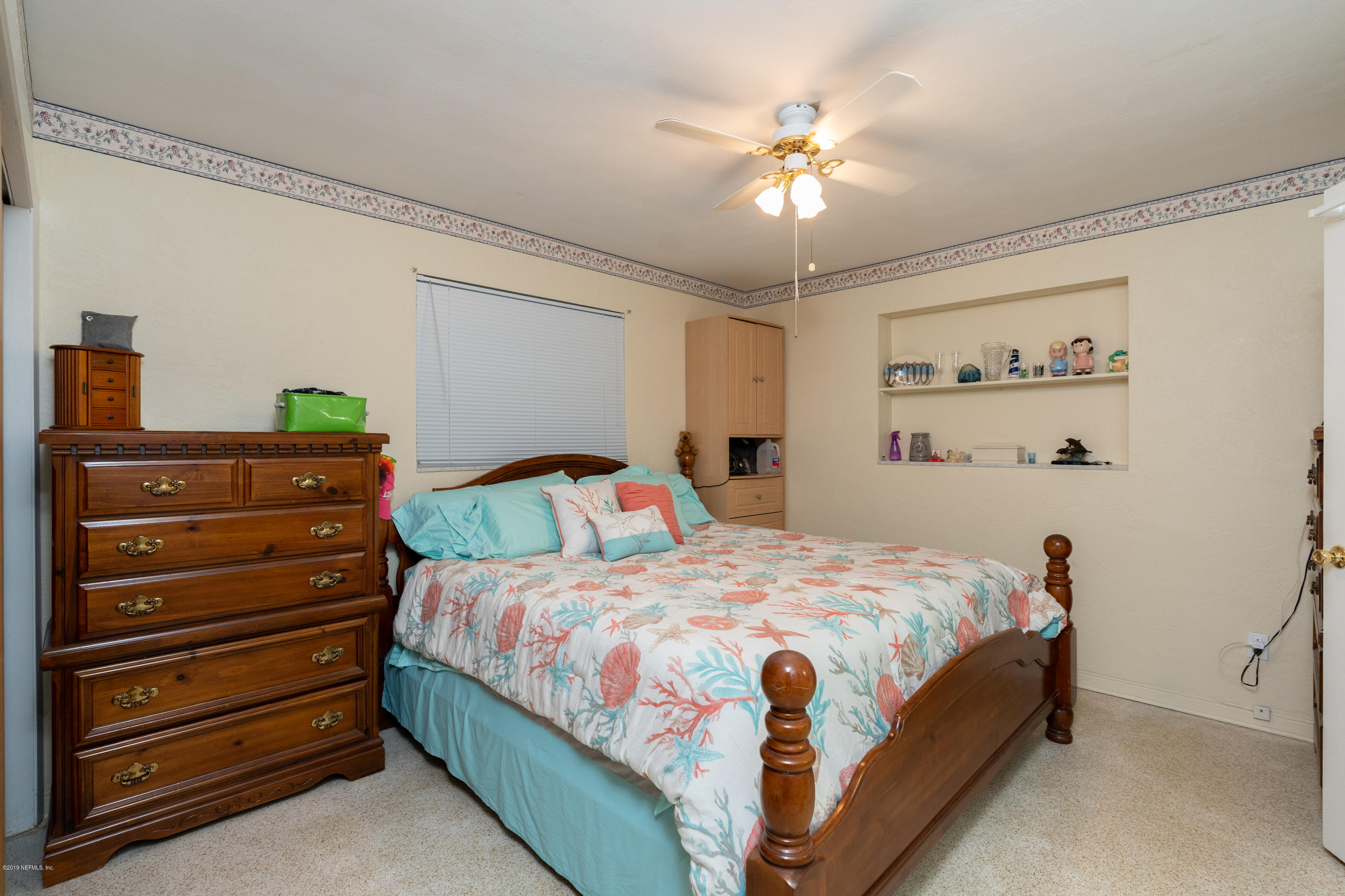 34 Ocean Drive St. Augustine, FL 32080 - Photo 25 of 36 a bedroom with a bed and a chandelier