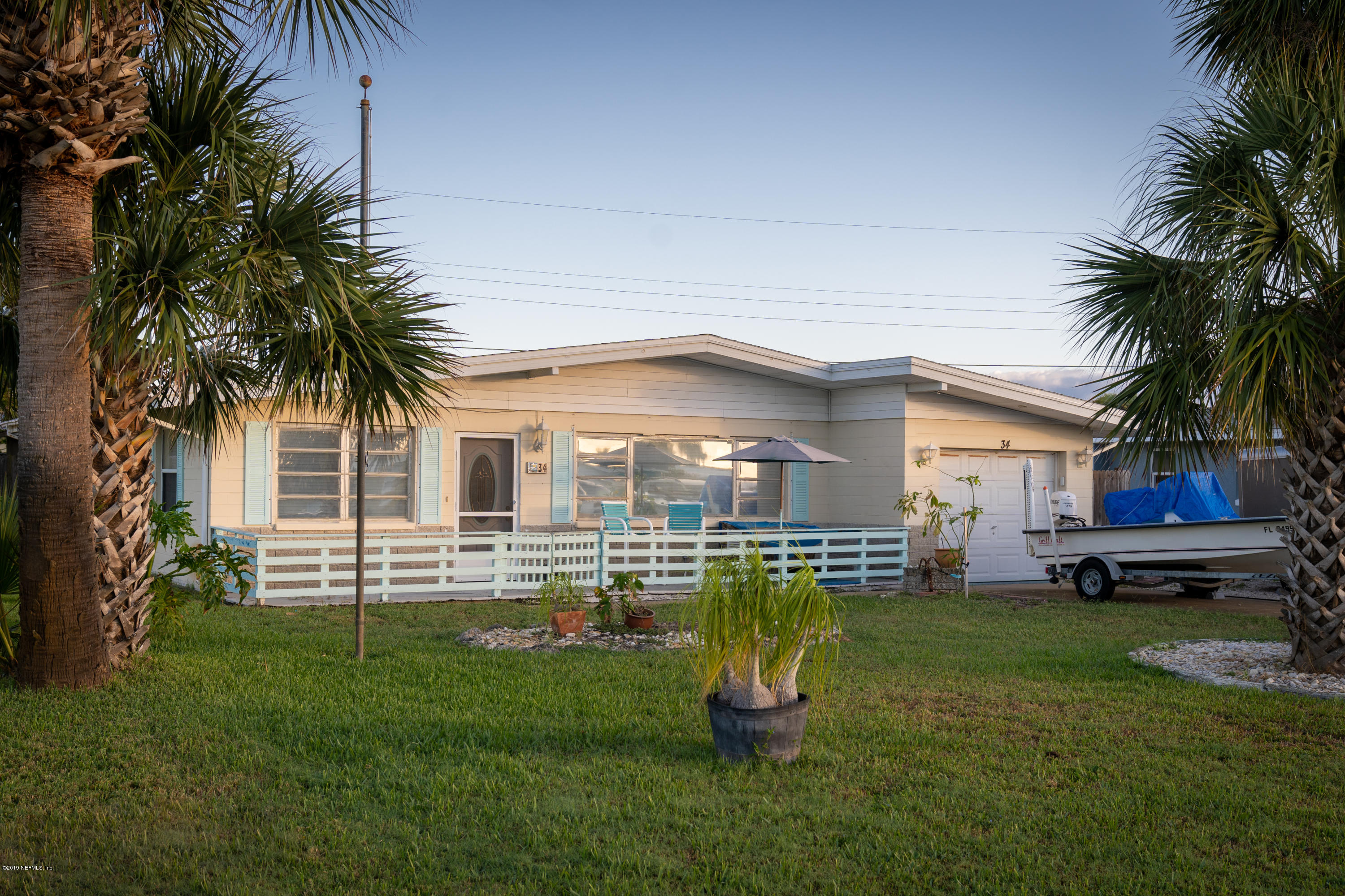34 Ocean Drive St. Augustine, FL 32080 - Photo 6 of 36 a front view of a house with a garden and tree