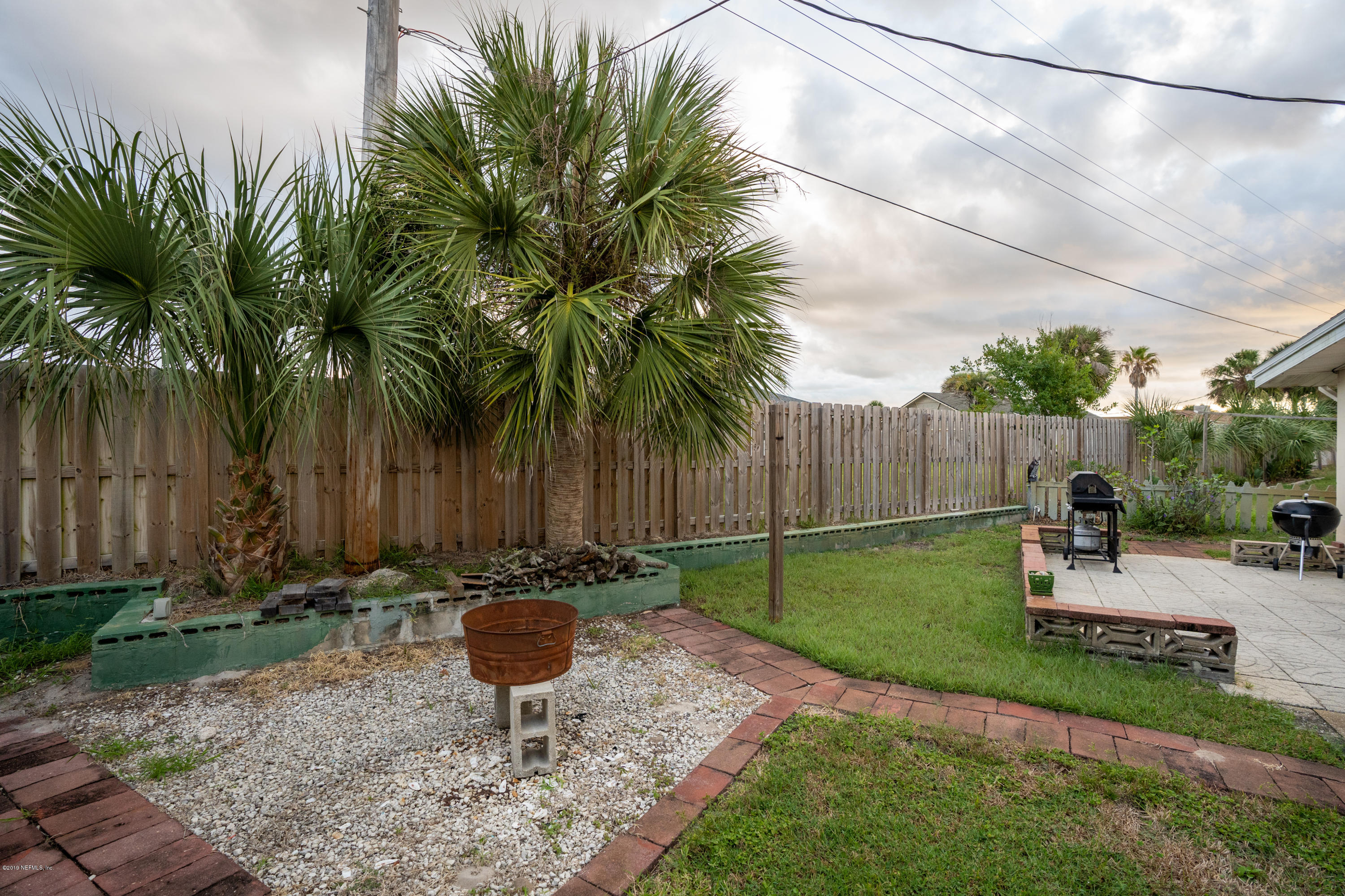 34 Ocean Drive St. Augustine, FL 32080 - Photo 9 of 36 a view of a backyard with potted plants and palm trees