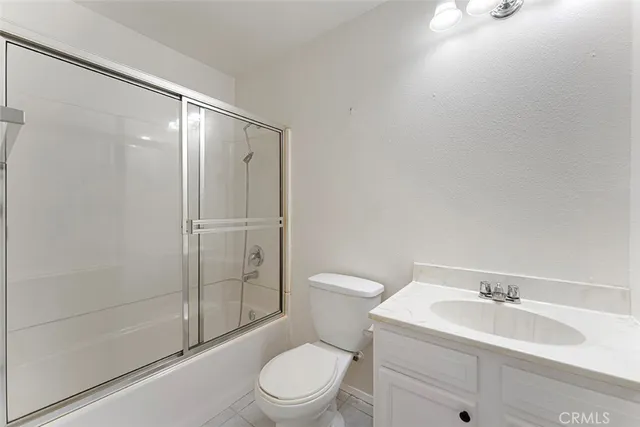 a bathroom with a toilet a sink and shower