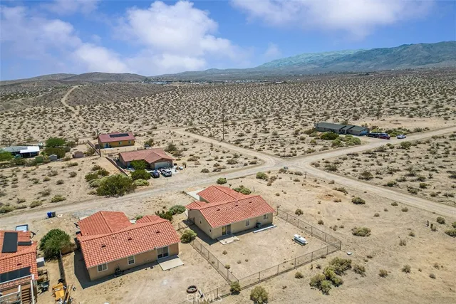 an aerial view of residential houses with outdoor space