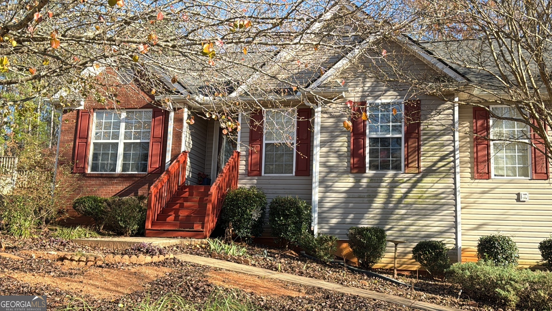 a view of a house with a yard and potted plants