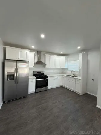 a kitchen with stainless steel appliances and white cabinets