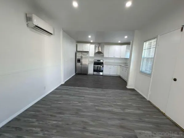 a view of a kitchen with a sink and wooden floor
