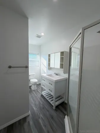 a room with a refrigerator and a sink