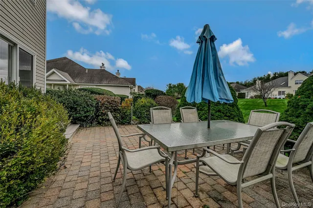 a view of a house with backyard and sitting area