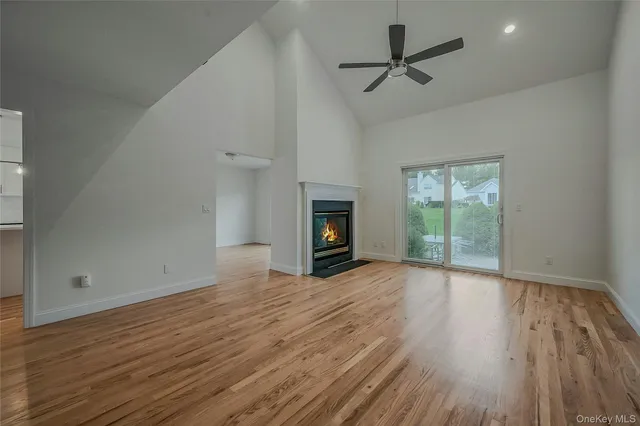 wooden floor fireplace and windows in an empty room