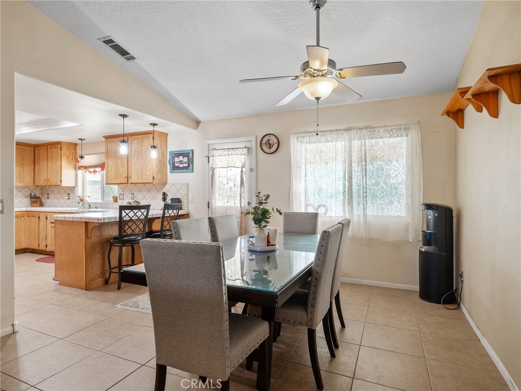 13776 Natoma Road Apple Valley, CA 92307 - Photo 17 of 40 a dining room with furniture and window