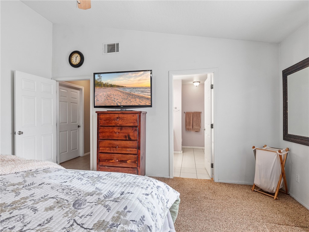 13776 Natoma Road Apple Valley, CA 92307 - Photo 25 of 40 a bedroom with a bed and a window