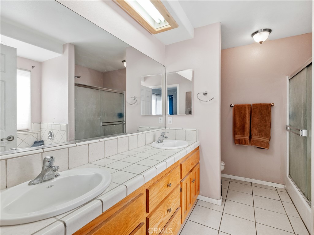13776 Natoma Road Apple Valley, CA 92307 - Photo 26 of 40 a bathroom with a granite countertop sink and a mirror