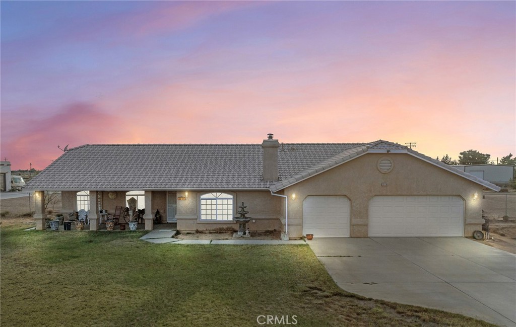 13776 Natoma Road Apple Valley, CA 92307 - Photo 5 of 40 a front view of a house with a yard and garage
