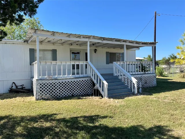 a view of a house with a wooden deck
