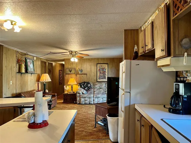 a kitchen with sink refrigerator and cabinets