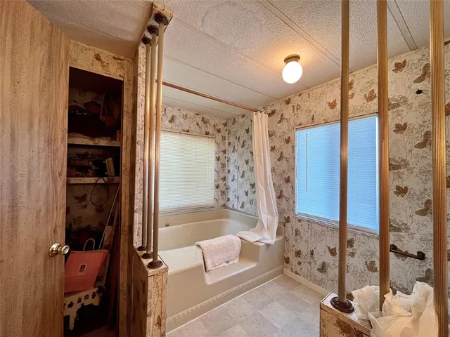 a bathroom with a tub and a shower