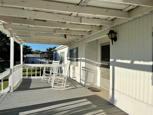 a view of a patio with table and chairs